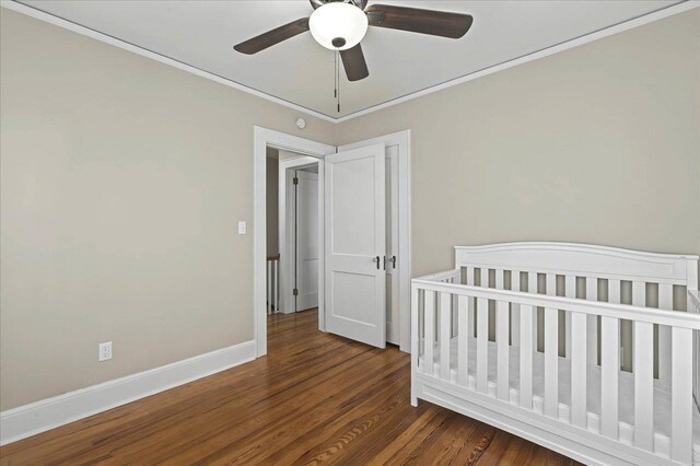 326 N 8th St, Quincy, FL 32351 - bedroom with dark wood-type flooring, crown molding, a ceiling fan, and a nursery area