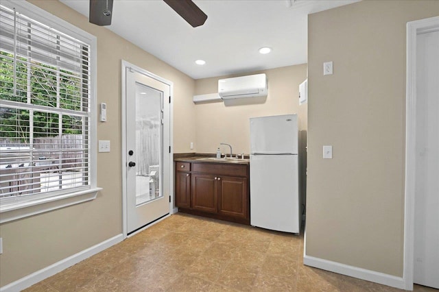 326 N 8th St, Quincy, FL 32351 - kitchen with freestanding refrigerator, an AC wall unit, ceiling fan, dark brown cabinets, and recessed lighting