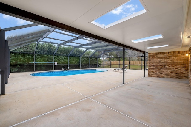 view of swimming pool with a patio and glass enclosure