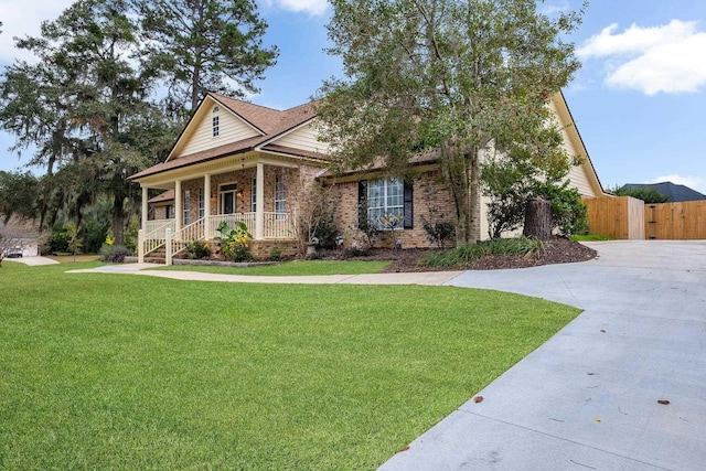 view of front of home with a porch and a front yard