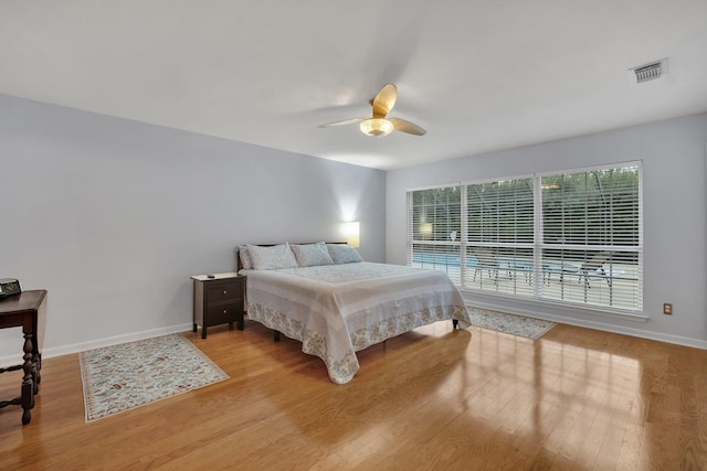 bedroom with ceiling fan and light hardwood / wood-style floors