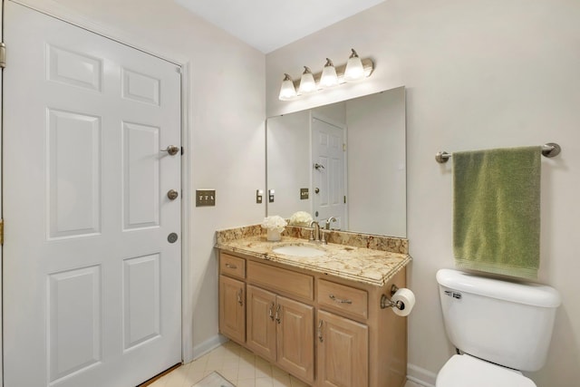 bathroom with vanity, toilet, and tile patterned flooring