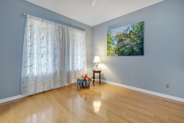 empty room featuring ornamental molding and light hardwood / wood-style floors