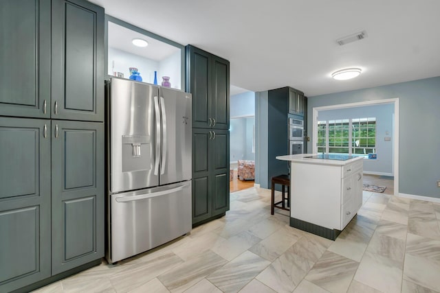 kitchen featuring a kitchen island, appliances with stainless steel finishes, and a kitchen breakfast bar