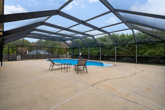 view of pool with a patio and glass enclosure