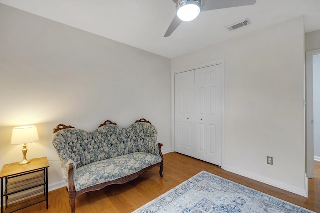 sitting room featuring ceiling fan and hardwood / wood-style floors