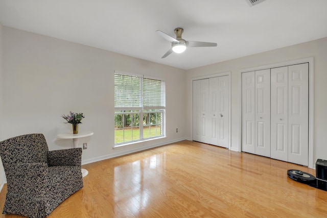 sitting room with hardwood / wood-style flooring and ceiling fan