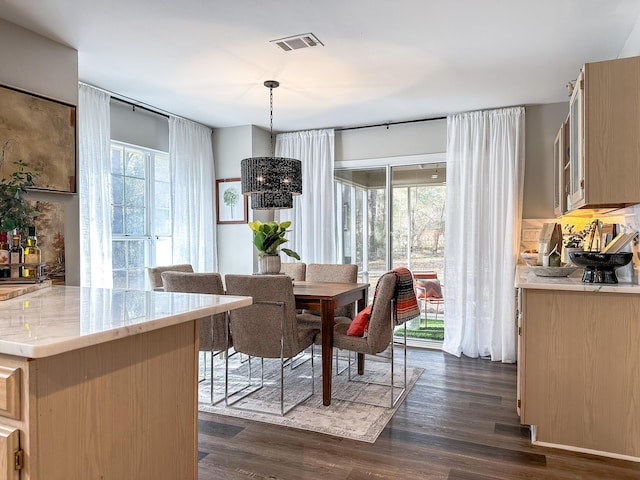 dining area with visible vents and dark wood-style floors