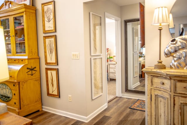 bathroom with wood finished floors and baseboards