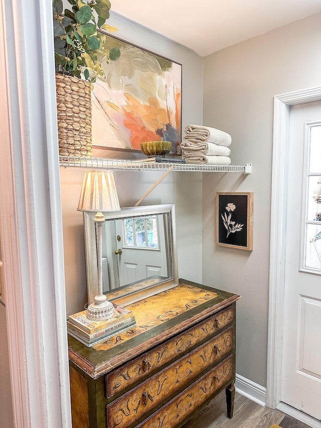 interior details featuring wood finished floors and baseboards