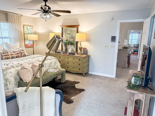 carpeted bedroom with baseboards and a ceiling fan