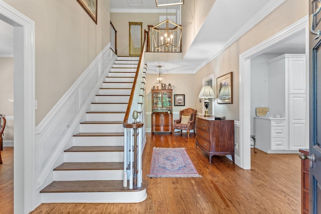 1244 Salem Rd, Havana, FL 32333 - stairway featuring crown molding, wood-type flooring, and an inviting chandelier
