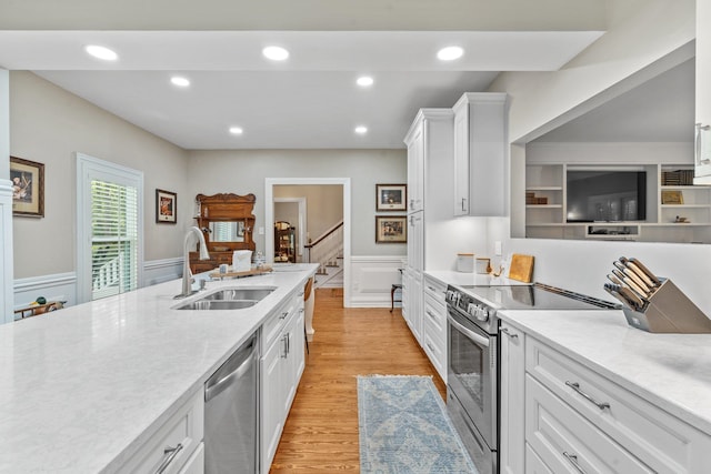 1244 Salem Rd, Havana, FL 32333 - kitchen featuring white cabinetry, sink, stainless steel appliances, and light hardwood / wood-style floors