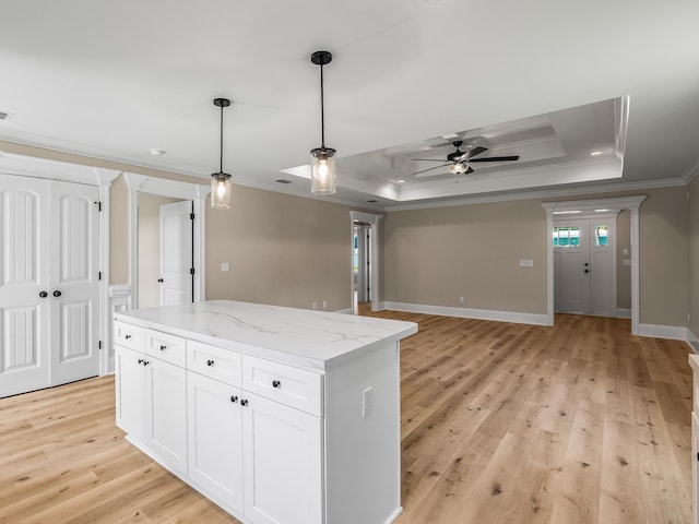 42 Duane Dr, Crawfordville, FL 32327 - kitchen with crown molding, a tray ceiling, light wood-style floors, a ceiling fan, and decorative light fixtures