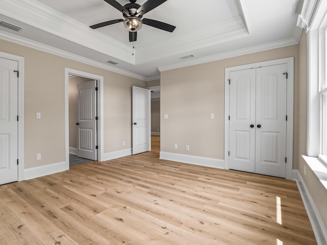42 Duane Dr, Crawfordville, FL 32327 - unfurnished bedroom with light wood-style floors, ornamental molding, a raised ceiling, and a ceiling fan