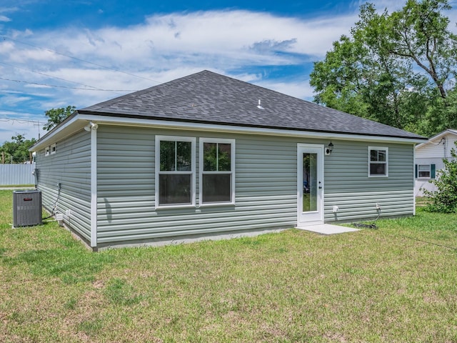 42 Duane Dr, Crawfordville, FL 32327 - rear view of house with a shingled roof and a yard