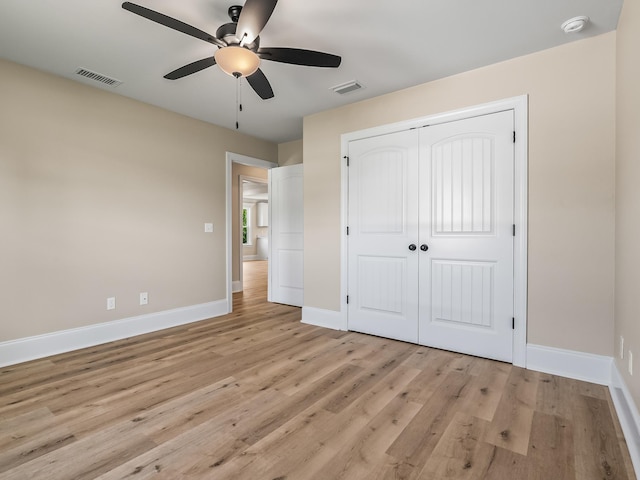 42 Duane Dr, Crawfordville, FL 32327 - unfurnished bedroom with light wood-style flooring, a closet, and a ceiling fan