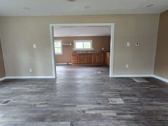 unfurnished living room featuring dark wood-type flooring