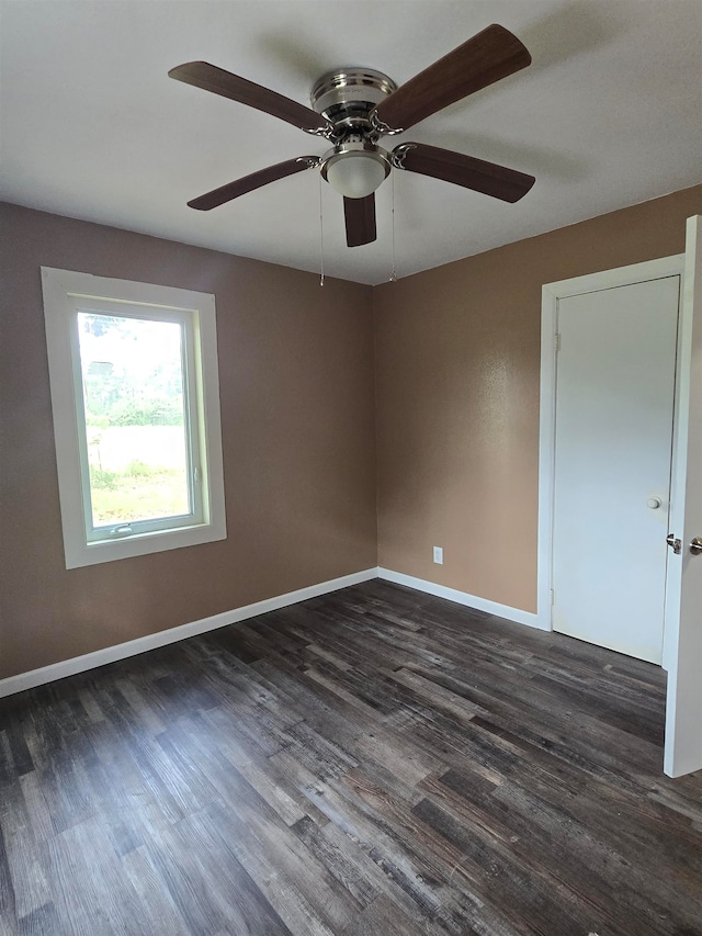 spare room featuring dark hardwood / wood-style floors and ceiling fan