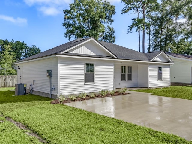 rear view of property with central AC, a yard, and a patio