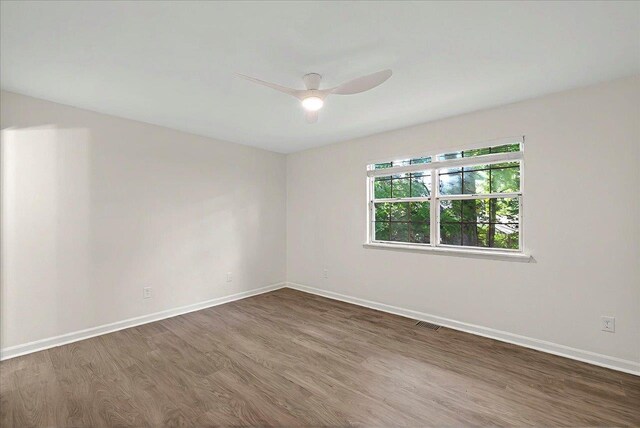 1138 Cherry Laurel St, Tallahassee, FL 32308 - empty room with wood finished floors, baseboards, and ceiling fan