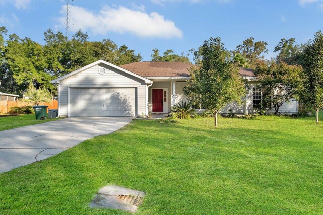 single story home with a garage, a front yard, and driveway