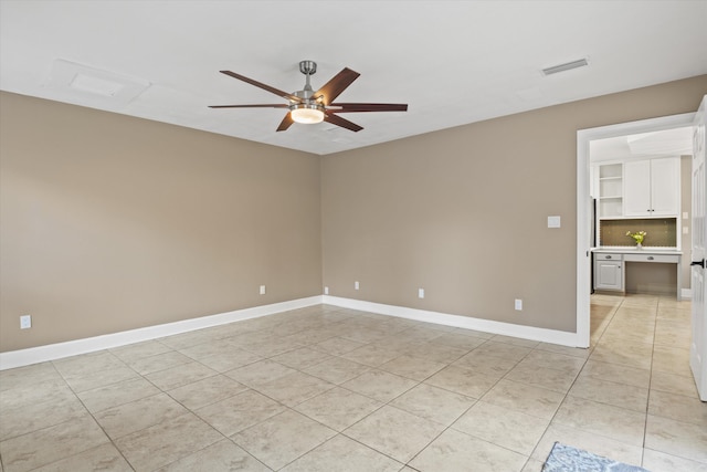 unfurnished room with ceiling fan and light tile patterned flooring