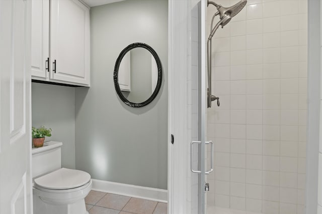 bathroom with tile patterned flooring, toilet, and walk in shower