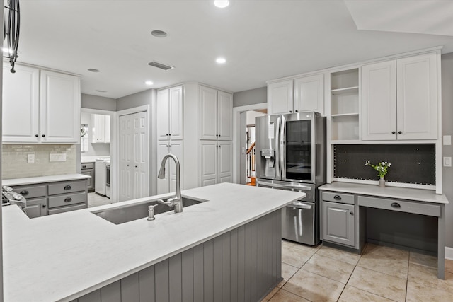 kitchen with gray cabinets, decorative light fixtures, white cabinetry, sink, and stainless steel fridge