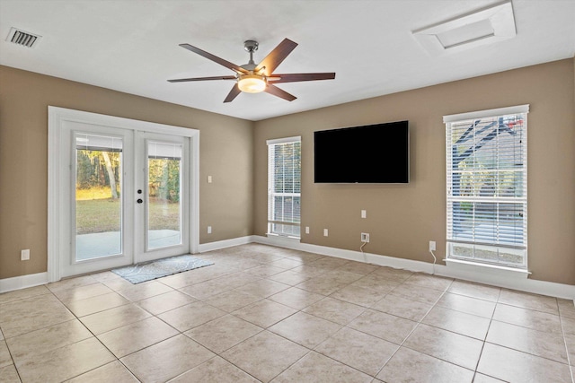 tiled empty room with french doors and ceiling fan