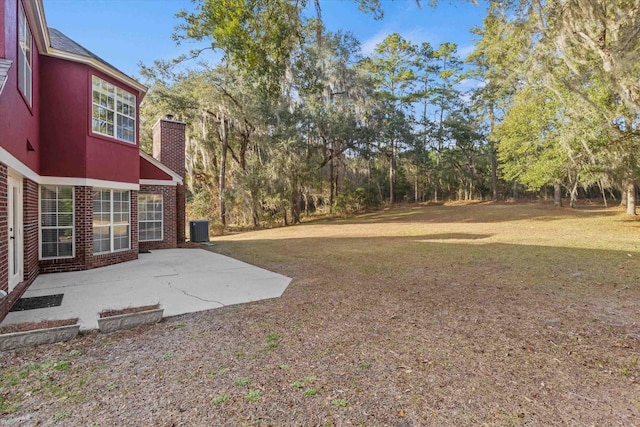 view of yard featuring central AC and a patio