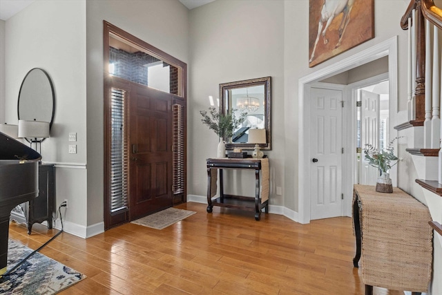 entrance foyer featuring a towering ceiling and light hardwood / wood-style flooring