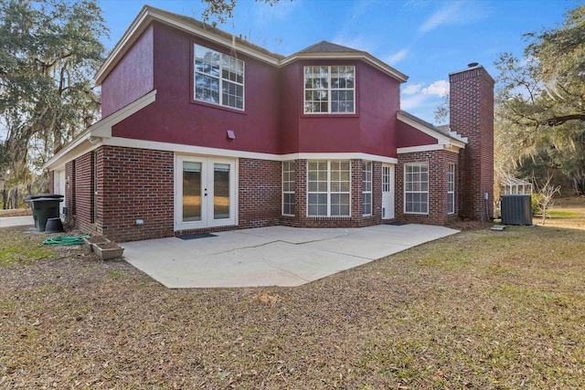 back of property with french doors, cooling unit, and a patio area