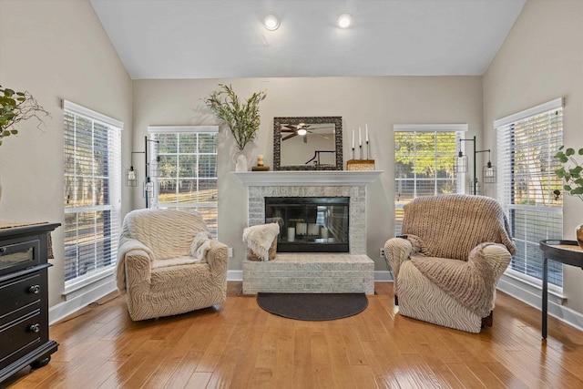 sitting room with wood-type flooring and high vaulted ceiling