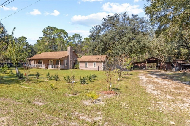 view of yard featuring a porch and a carport