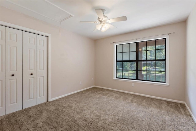 unfurnished bedroom with a closet, carpet flooring, and ceiling fan