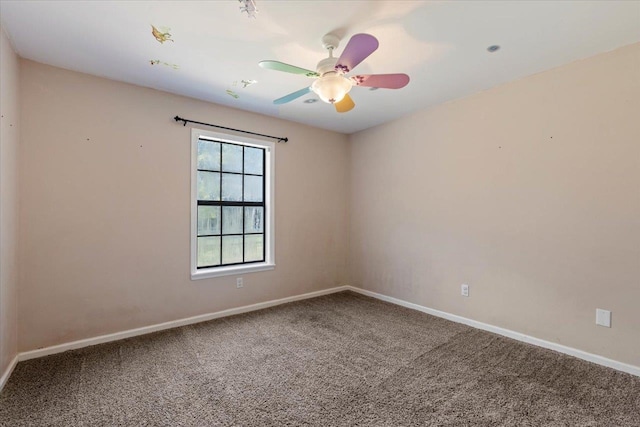 unfurnished room with ceiling fan and carpet flooring