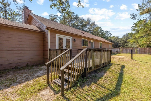 rear view of house with a yard and a deck