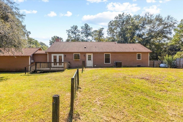 back of house featuring cooling unit, a lawn, and a deck