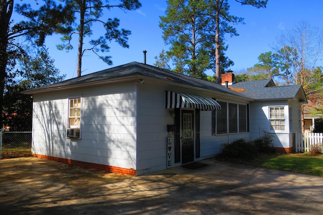 915 Hillcrest Ave, Quincy, FL 32351 - view of home's exterior with a chimney, roof with shingles, and cooling unit