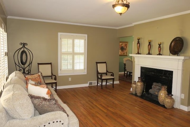 915 Hillcrest Ave, Quincy, FL 32351 - living room featuring wood finished floors, crown molding, baseboards, and a fireplace