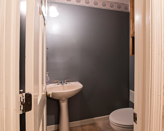 bathroom featuring toilet and tile patterned flooring