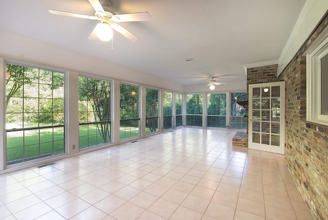 unfurnished sunroom with ceiling fan