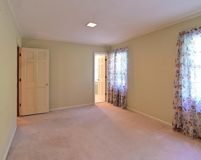 carpeted spare room with crown molding