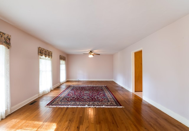 unfurnished room featuring ceiling fan and wood-type flooring