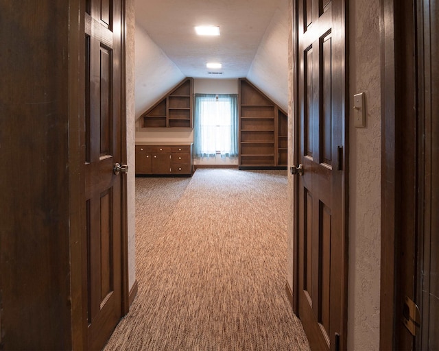 additional living space with vaulted ceiling and dark carpet