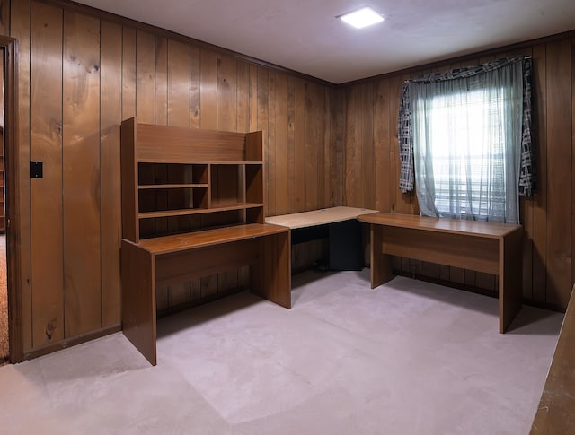 home office featuring wood walls and light colored carpet