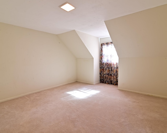 bonus room featuring light carpet and vaulted ceiling