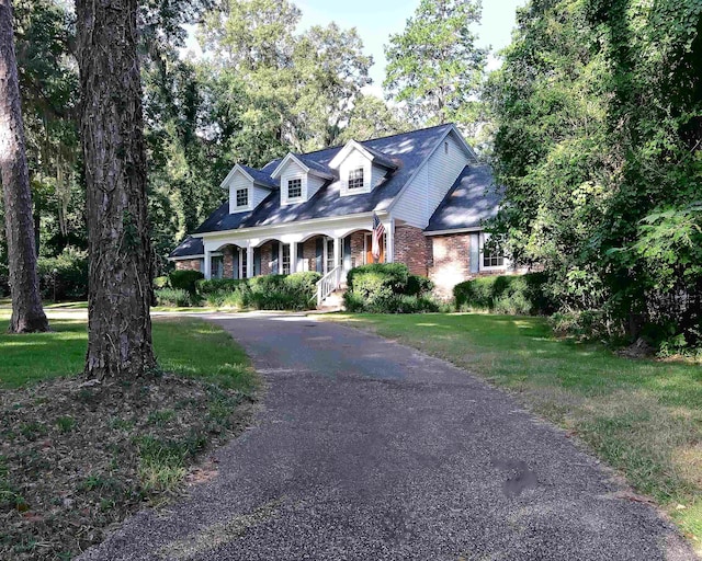 cape cod home with a porch and a front yard