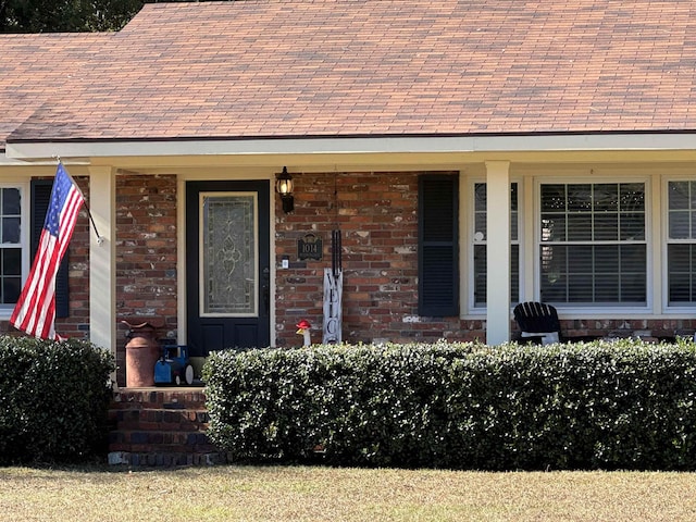 entrance to property featuring brick siding